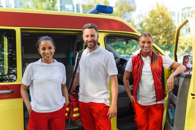 Paramédicos no trabalho com uma ambulância Enfermeira paramédica e médico de emergência na ambulância com kit