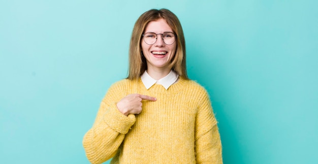 Parecendo feliz, orgulhoso e surpreso, apontando alegremente para se sentir confiante e elevado