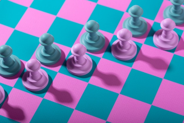 Foto grátis peças verdes e rosa para xadrez com tabuleiro de jogo
