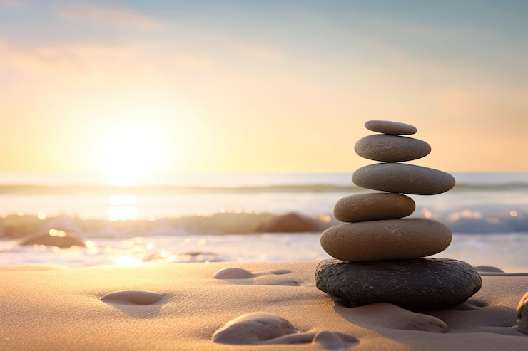 Foto grátis pedras zen equilibradas na praia com espaço para texto luz do nascer do sol meditação e relaxamento ai generative