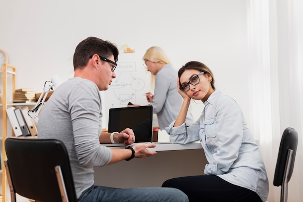 Pensando mulher falando com o homem no escritório