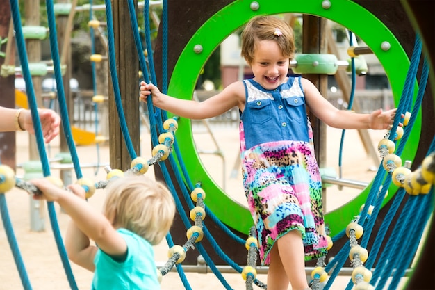 Pequenas irmãs no parque infantil no parque