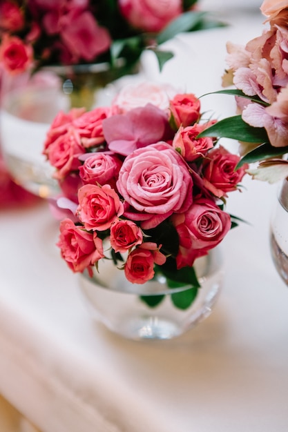 Pequeno buquê de rosas rosas colocou vaso de vidro