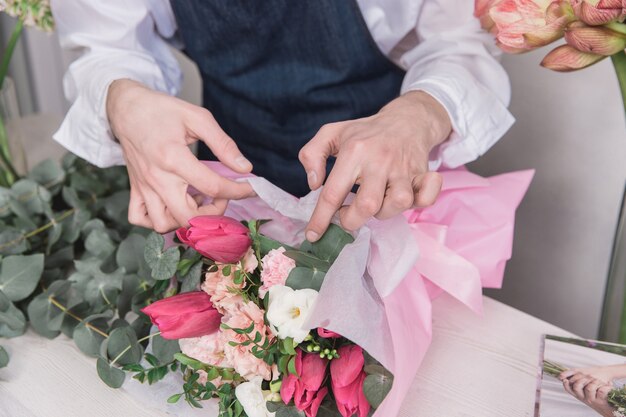 Pequenos negócios. Florista masculina na loja de flores.