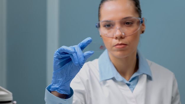 Perto de um médico de biologia olhando para um exame de sangue