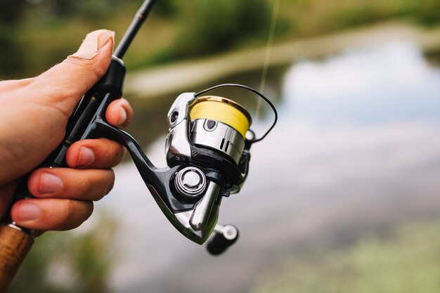 Pescador, segurando, cana de pesca, ligado, desfoque, fundo