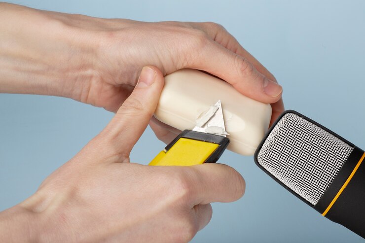 Foto grátis pessoa cortando barra de sabão perto do microfone para asmr