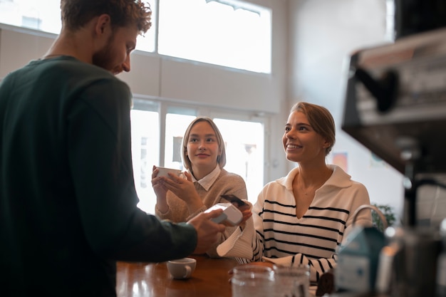 Foto grátis pessoa que usa a tecnologia nfc para pagar em um restaurante