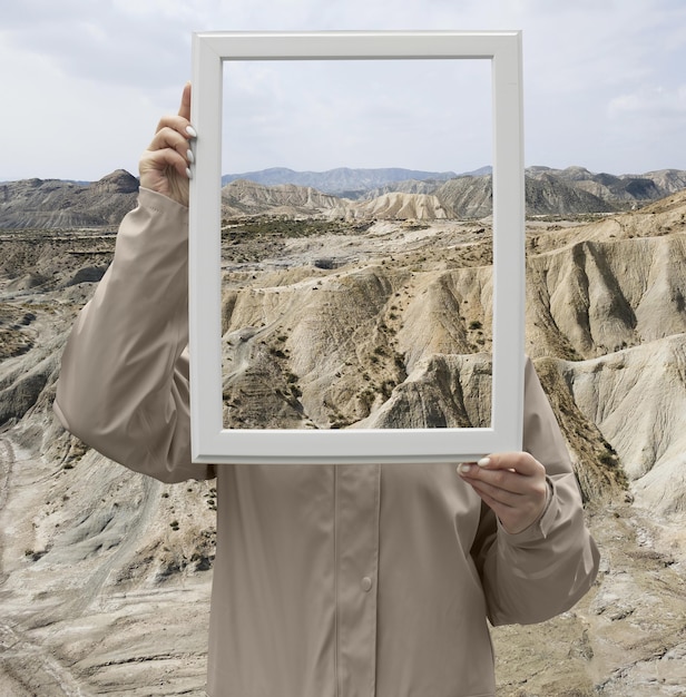 Foto grátis pessoa segurando quadro com conceito de paisagem de natureza aberta