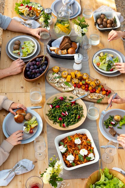 Pessoas à mesa com comida de perto