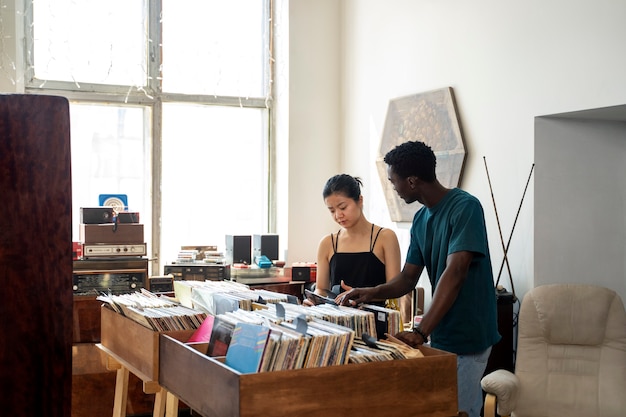 Foto grátis pessoas com vista lateral de discos de vinil