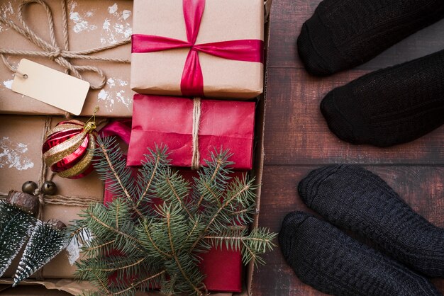 Pessoas de pé no chão com caixas de presente em caixa de papelão