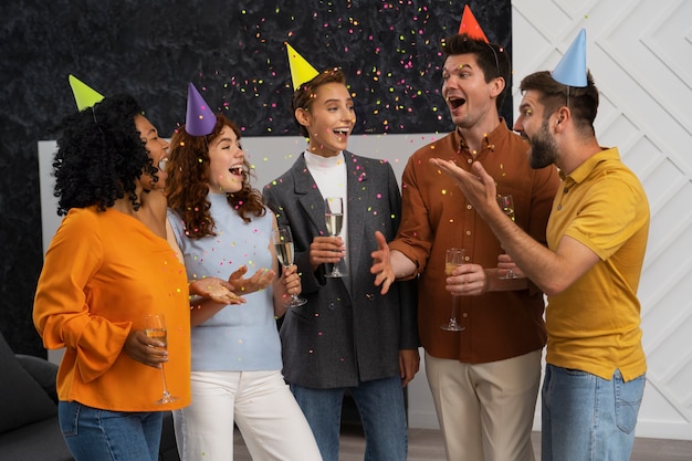 Foto grátis pessoas sorridentes de tiro médio com chapéus de festa