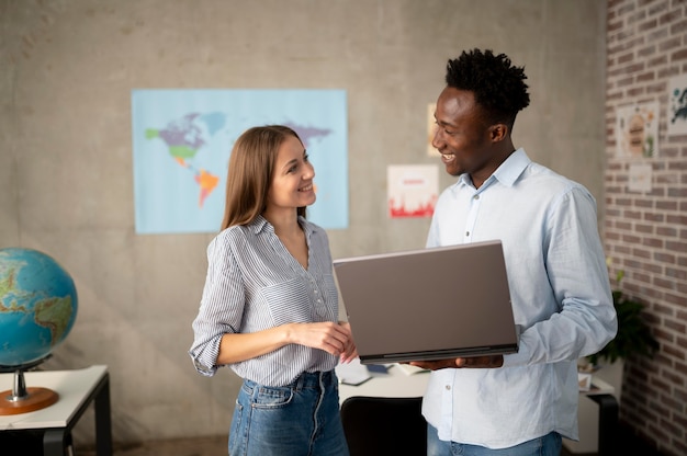 Foto grátis pessoas sorridentes de tiro médio com laptop