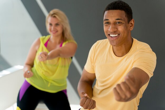 Pessoas sorridentes se divertindo na aula de zumba