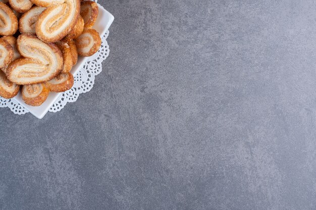 Foto grátis pilha de deliciosos biscoitos em uma tigela branca.