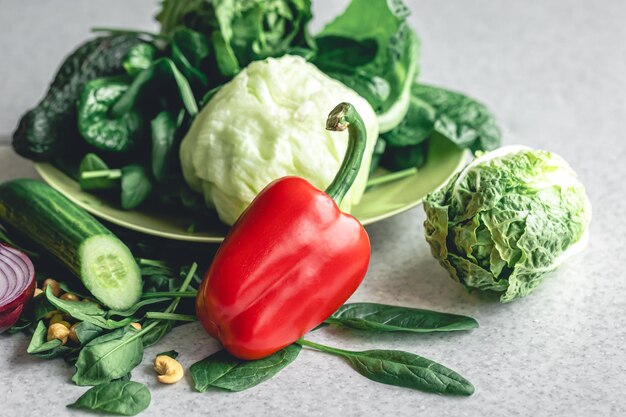 Pimenta vermelha, repolho e pepinos na mesa da cozinha.