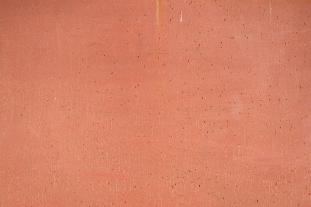 Foto grátis pintado em fundo laranja velho de metal rachado enferrujado.