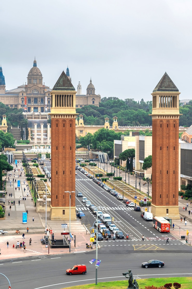 Foto grátis plaza de espana, the venetian towers e the palau nacional em barcelona, espanha. céu nublado, trânsito