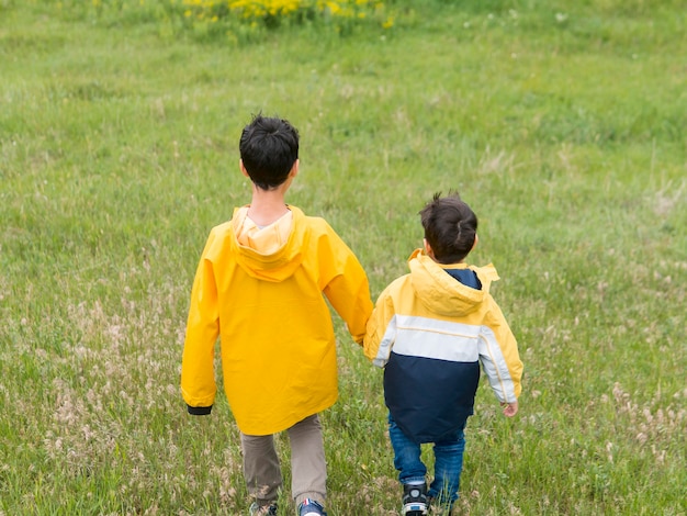 Por trás tiro irmãos de mãos dadas