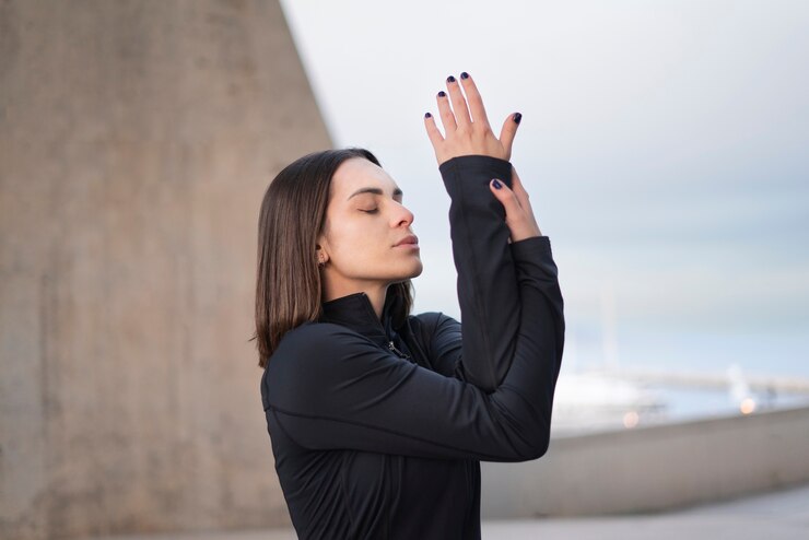 Foto grátis pose de meditação de mulher de tiro médio