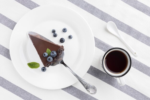 Posição plana da fatia de bolo de chocolate no prato