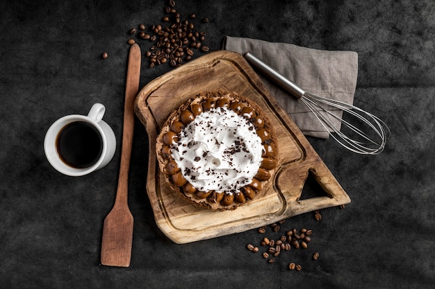 Postura plana de delicioso bolo com batedor e café