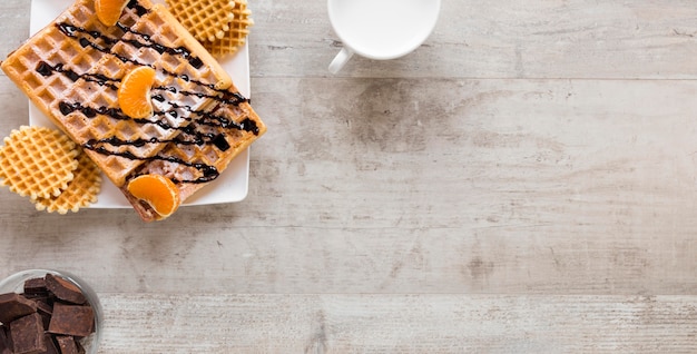 Foto grátis postura plana de waffles no prato com leite e chocolate