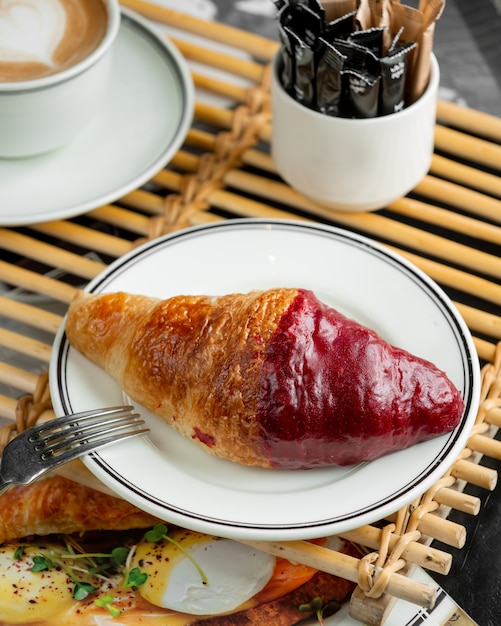 Foto grátis prato de croissant meio coberto de calda de morango