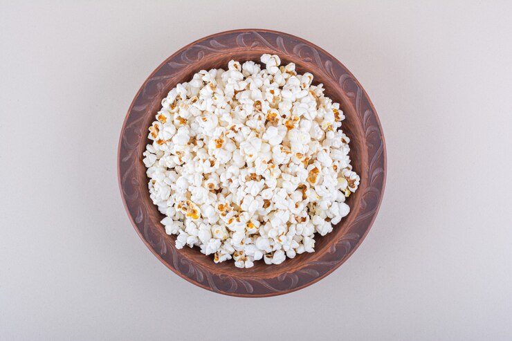 Foto grátis prato de pipoca salgada para a noite de cinema em fundo branco. foto de alta qualidade