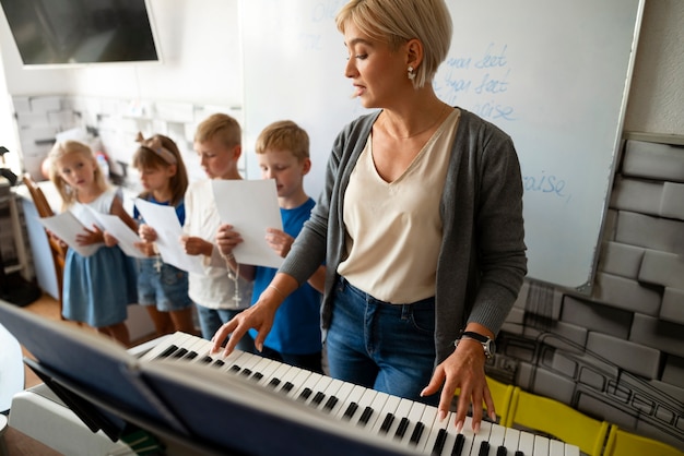 Foto grátis professor de tiro médio tocando piano