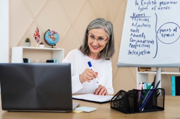 Foto grátis professora sorridente de inglês fazendo aulas online