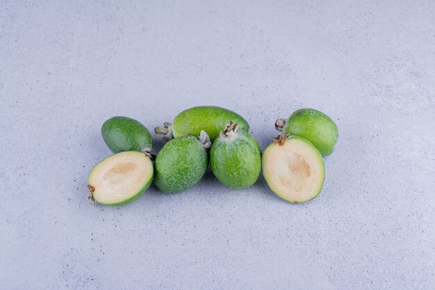 Foto grátis punhado de feijoas frescas em fundo de mármore. foto de alta qualidade