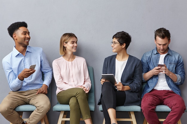 Foto grátis quatro jovens não conhecidos conversam animadamente