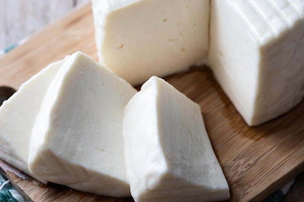 Foto grátis queijo branco fresco em fatias de leite de vaca sobre fundo branco