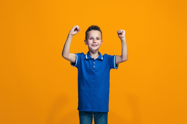 Rapaz adolescente sucesso feliz comemorando ser um vencedor. Imagem energética dinâmica do modelo feminino