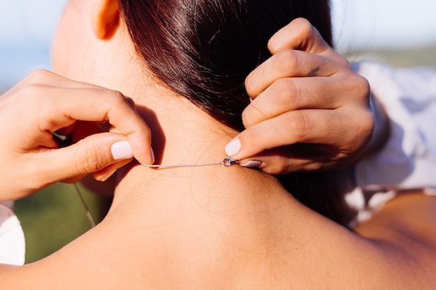 Retrato ao ar livre do colar usando as costas da mulher asiática.