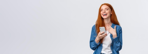 Foto grátis retrato da cintura para baixo, despreocupado e alegre, ruiva atraente, caucasiana, receba uma mensagem de meme engraçada