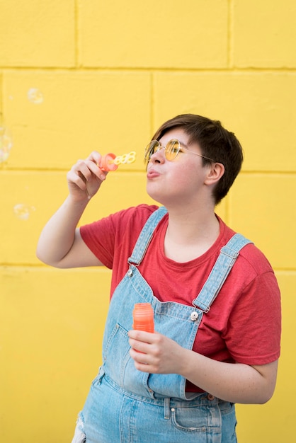 Foto grátis retrato de adolescente soprando bolhas