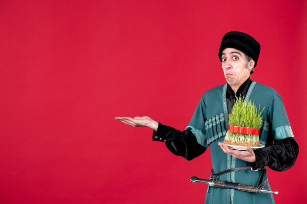 Retrato de azeri em traje tradicional segurando sêmen verde na dançarina vermelha étnica feriado novruz primavera