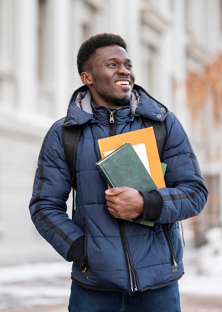 Retrato de estudante masculino com livros