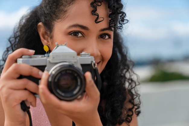 Retrato de fotógrafa feminina ao ar livre com câmera