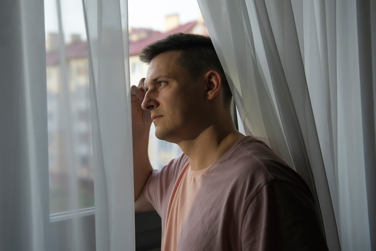 Foto grátis retrato de homem adulto com cortinas e sombra da janela