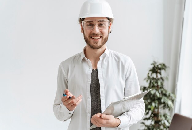 Retrato de homem com capacete no escritório