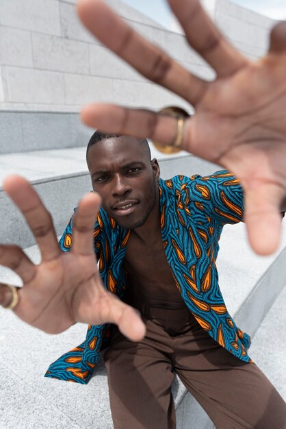 Foto grátis retrato de homem posando em traje tradicional africano ao ar livre