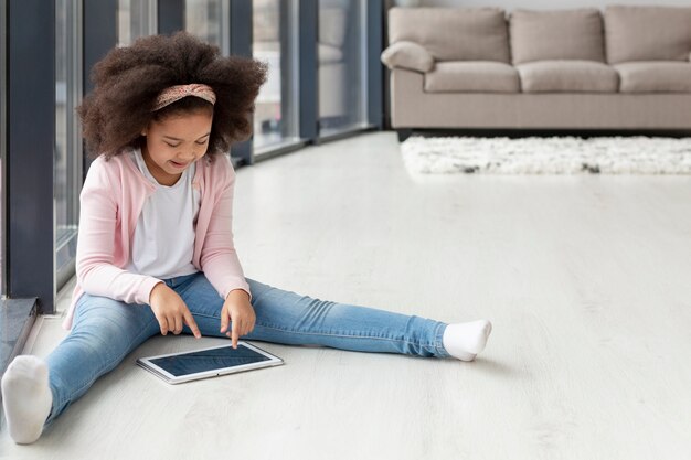 Foto grátis retrato de jovem navegando tablet em casa