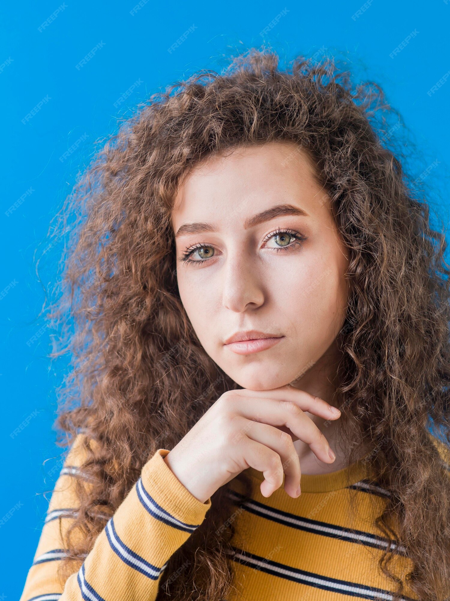 Retrato de menina com cabelos cacheados e olhos verdes