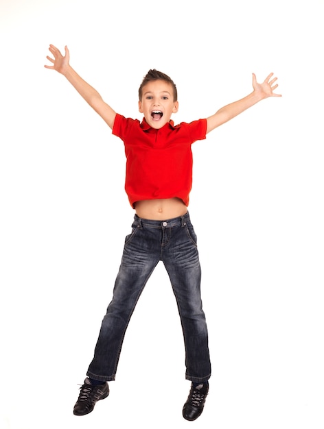 Retrato de menino feliz rindo pulando com as mãos levantadas -