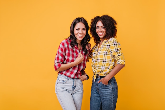 Retrato de modelos charmosos com aparência atraente. Garotas animadas parecem felizes