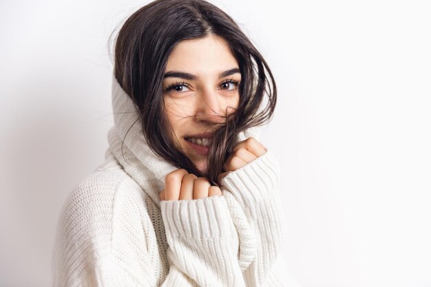 Retrato de mulher bonita isolada no branco. Conforto, calor no conceito de inverno